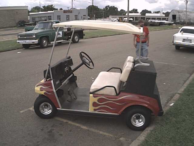 Pimp my cart Jeredrif style!!!, Yes ladies and gentlemen this is boredom at its best!!  Here is my Memphis Car Audio Demo Cart I built with friend in fit of extreme boredom. Yea that is a golfcart with Neons,chrome wheels,Candy paint, 7' in motorized LCD,CD,CDR,CDRW,DVD Player, Sony Competition CD-player, Memphis  5.25's, 2 Memphis M-class 10's in custom bandpass enclosure, Memphis 250D amp in flush, Playstation 2 and strobes on the front that ya cant see :)